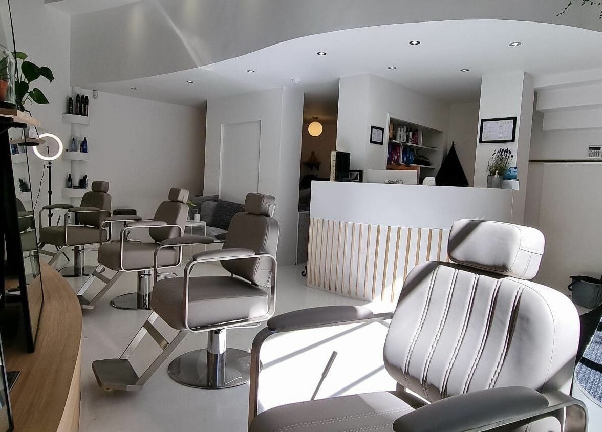 Modern interior of K&Co Hair Salon in London, England, GB, featuring stylish chairs and sleek design.