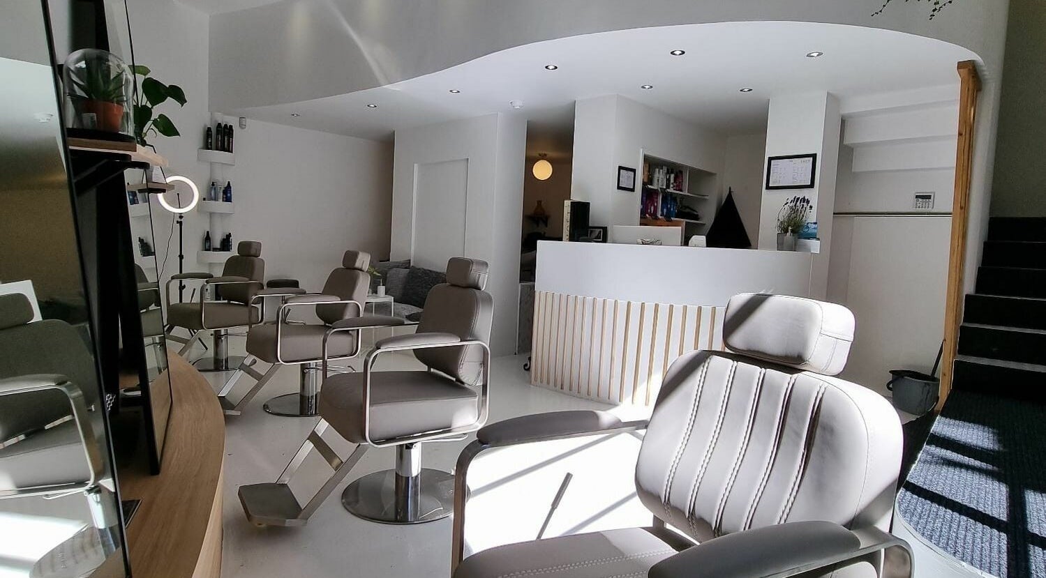 Modern interior of K&Co Hair Salon in London, England, GB, featuring stylish chairs and sleek design.