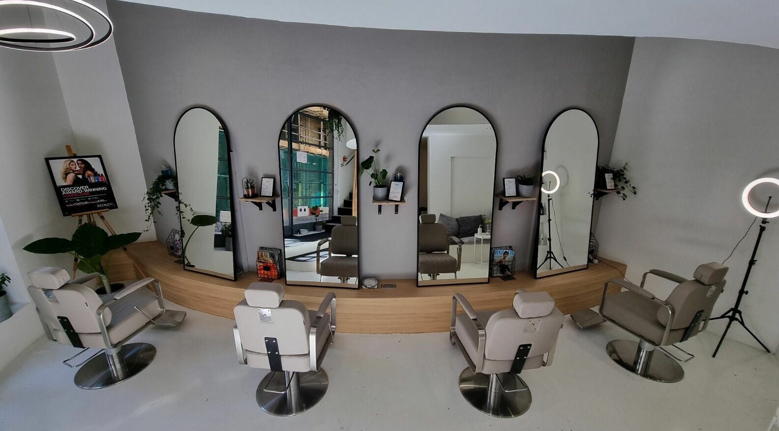 Modern interior of K&Co Hair Salon in London, England with stylish chairs and mirrors.