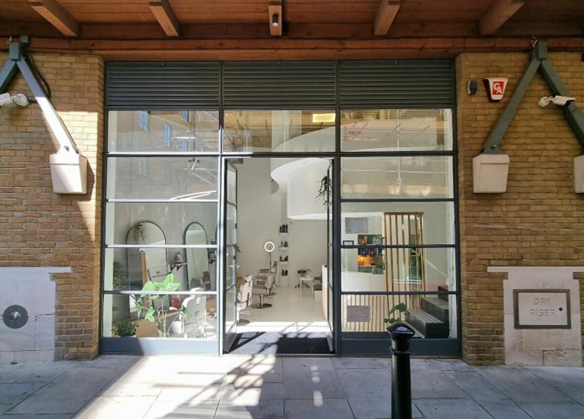 Exterior view of K&Co Hair Salon in London, England, GB, showcasing its stylish brick facade and inviting entrance.
