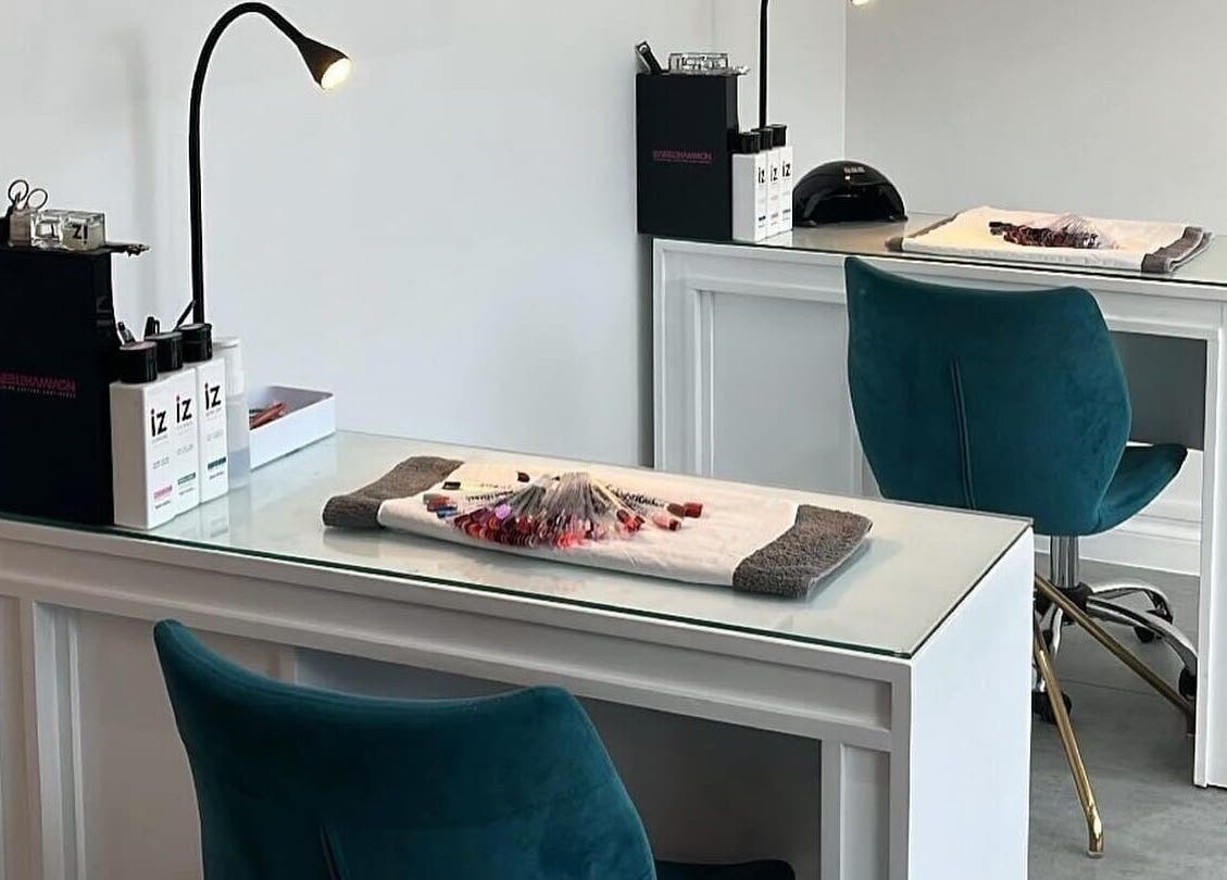 Chic nail station at Be beautiful by Alex, Glenfield, England, GB. Modern design with teal chairs and manicure tools.
