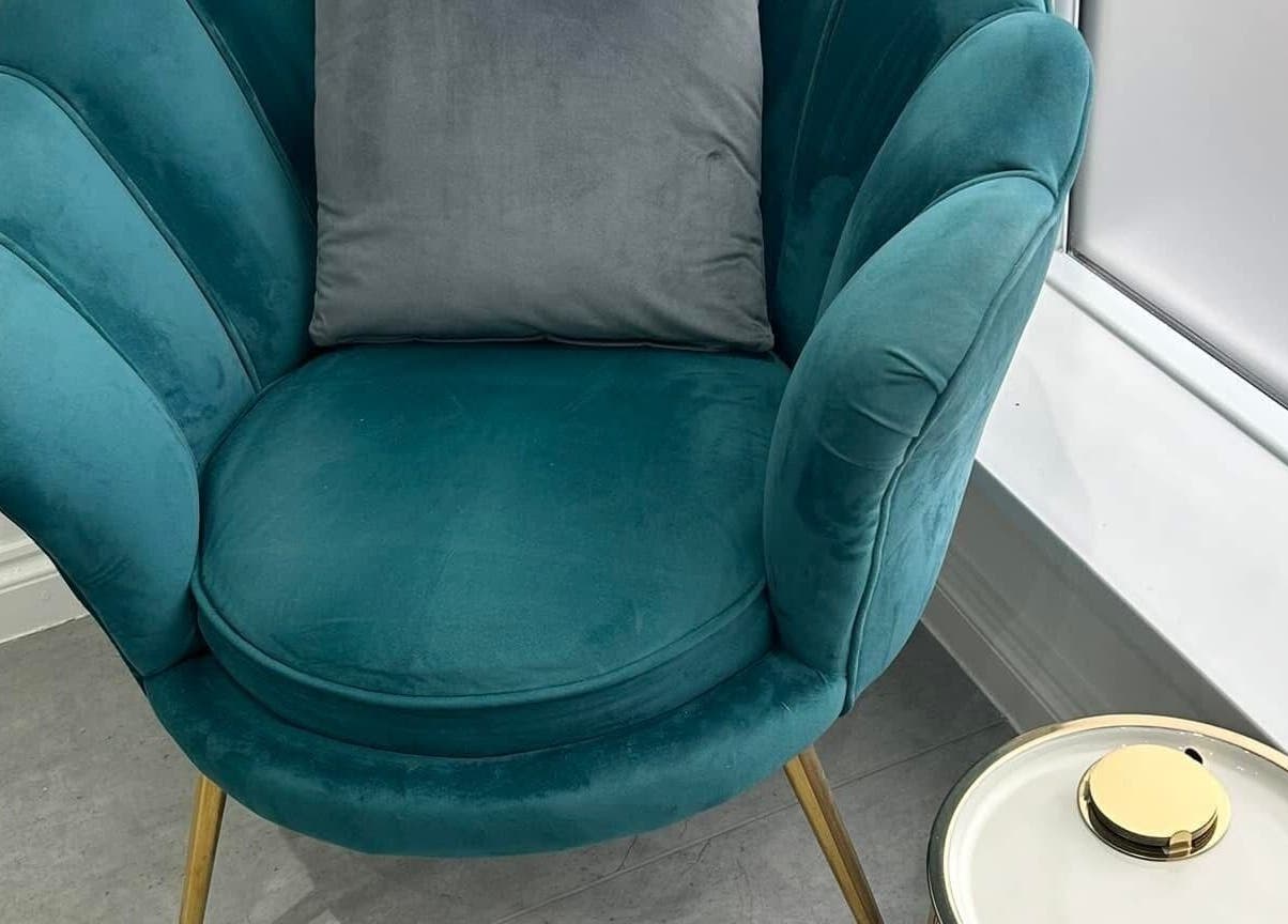 Luxurious teal chair with cushion at Be Beautiful by Alex, Glenfield, England, GB for a relaxing experience.