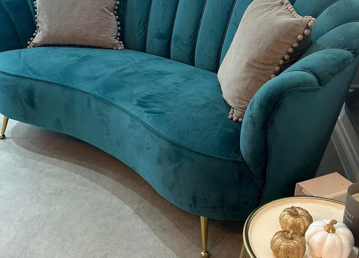 Luxurious teal sofa with elegant decor at Be Beautiful by Alex, Glenfield, England, GB.