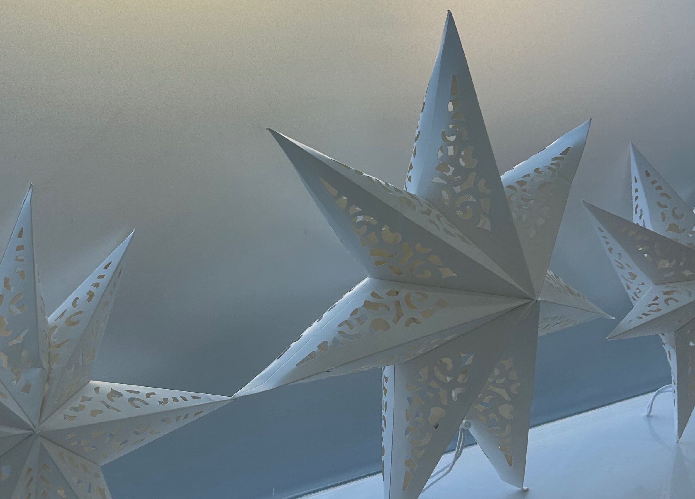 Elegant paper star decor at Be Beautiful by Alex, Glenfield, England, GB, enhancing the tranquil atmosphere.