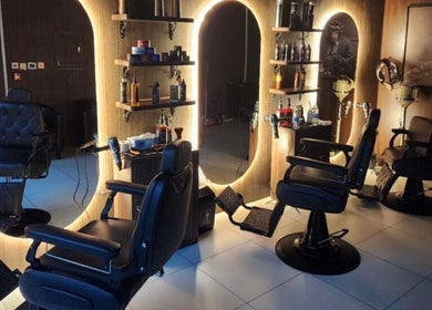 Elegant barbershop interior at The Barber House - Azizi Riviera, Dubai, Dubai, AE with stylish chairs and mirrors.