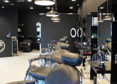 Modern interior of The Barber House - JLT in Dubai, Dubai, AE, showcasing sleek chairs and stylish decor.