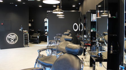 Modern interior of The Barber House - JLT in Dubai, Dubai, AE, showcasing sleek chairs and stylish decor.