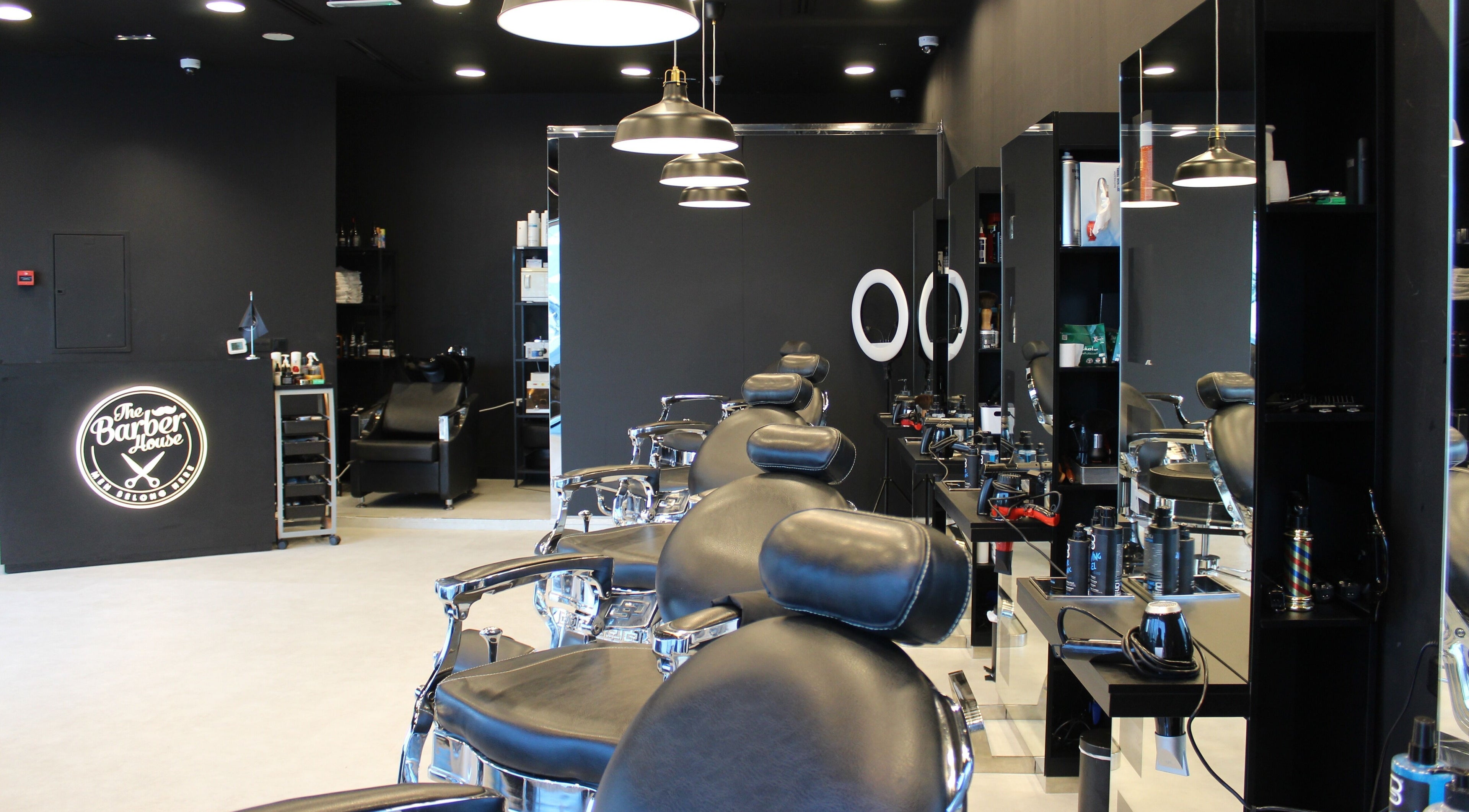 Interior of The Barber House - JLT, Dubai, Dubai, AE featuring sleek chairs and modern decor.