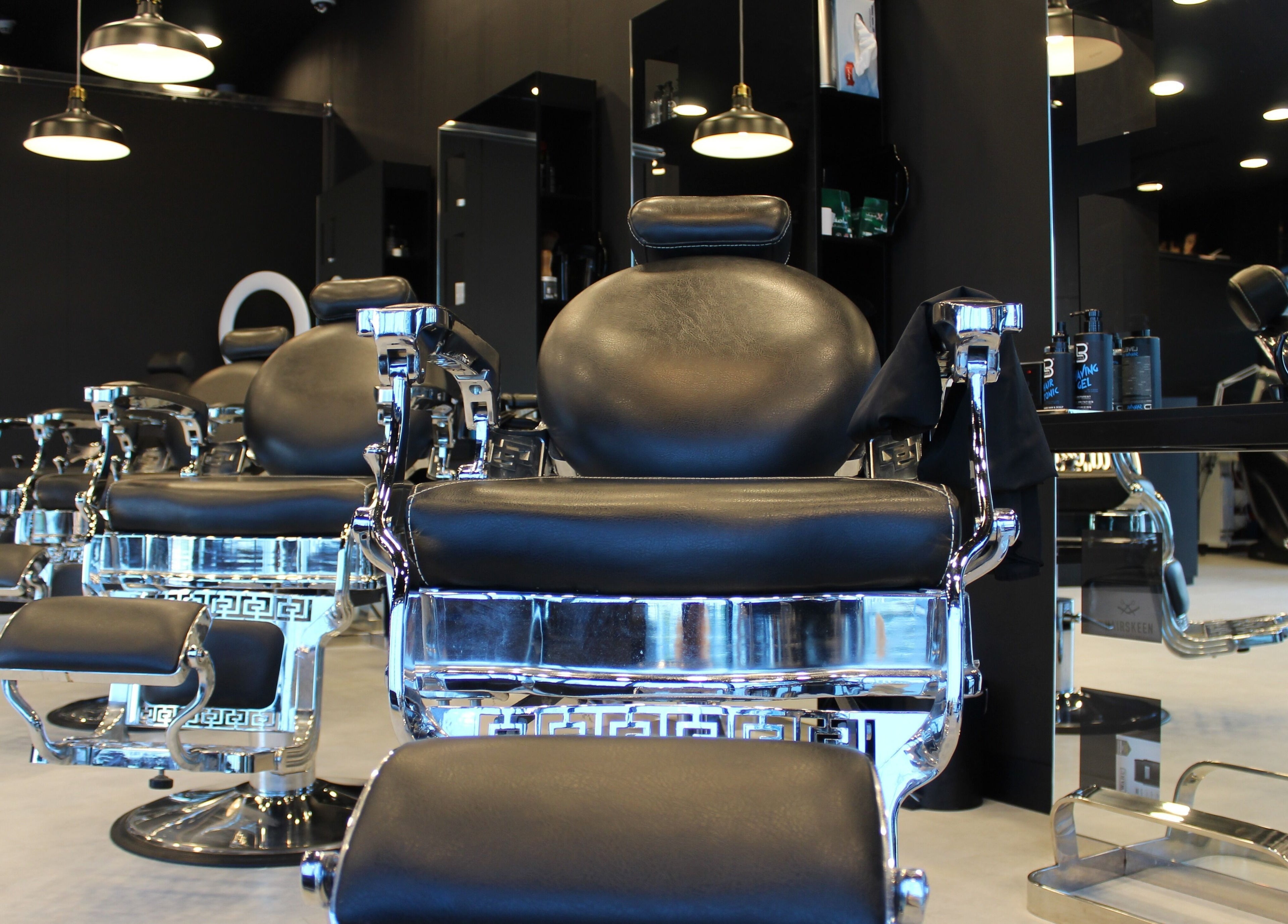 Elegant barber chairs at The Barber House - JLT, Dubai, Dubai, AE, showcasing luxury and style.