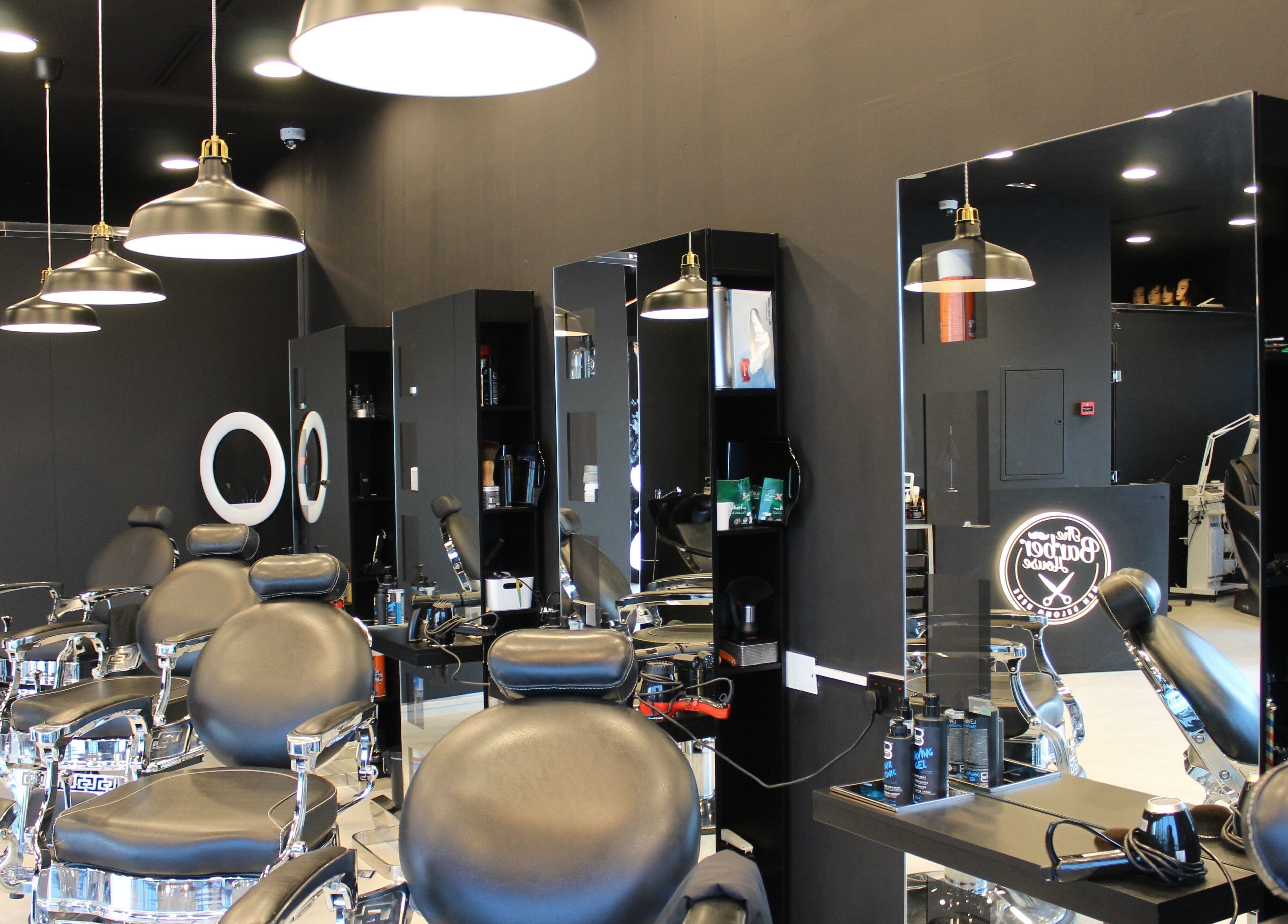 Sleek interior of The Barber House - JLT, featuring modern chairs. Located in Dubai, Dubai, AE.