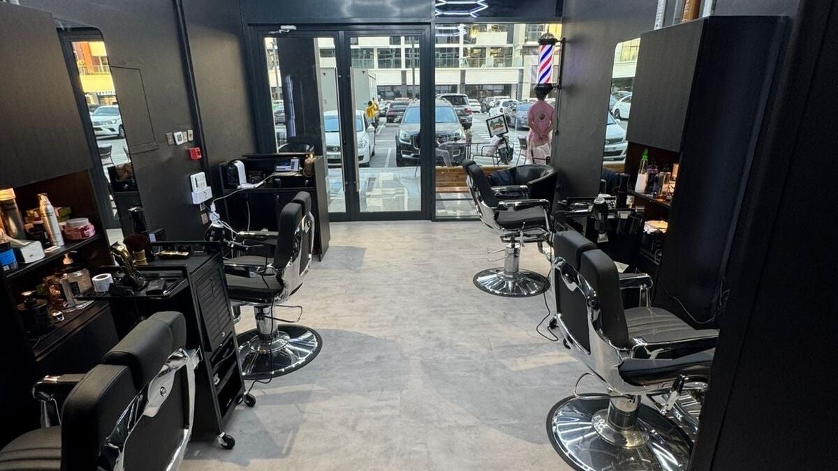 Modern barber shop interior at The Barber House - Azizi Riviera, Dubai, Dubai, AE with chic black chairs.
