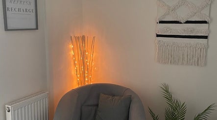 Cozy seating area with warm lighting at In-Touch Therapies by Frances, Pontypool, Wales, GB.