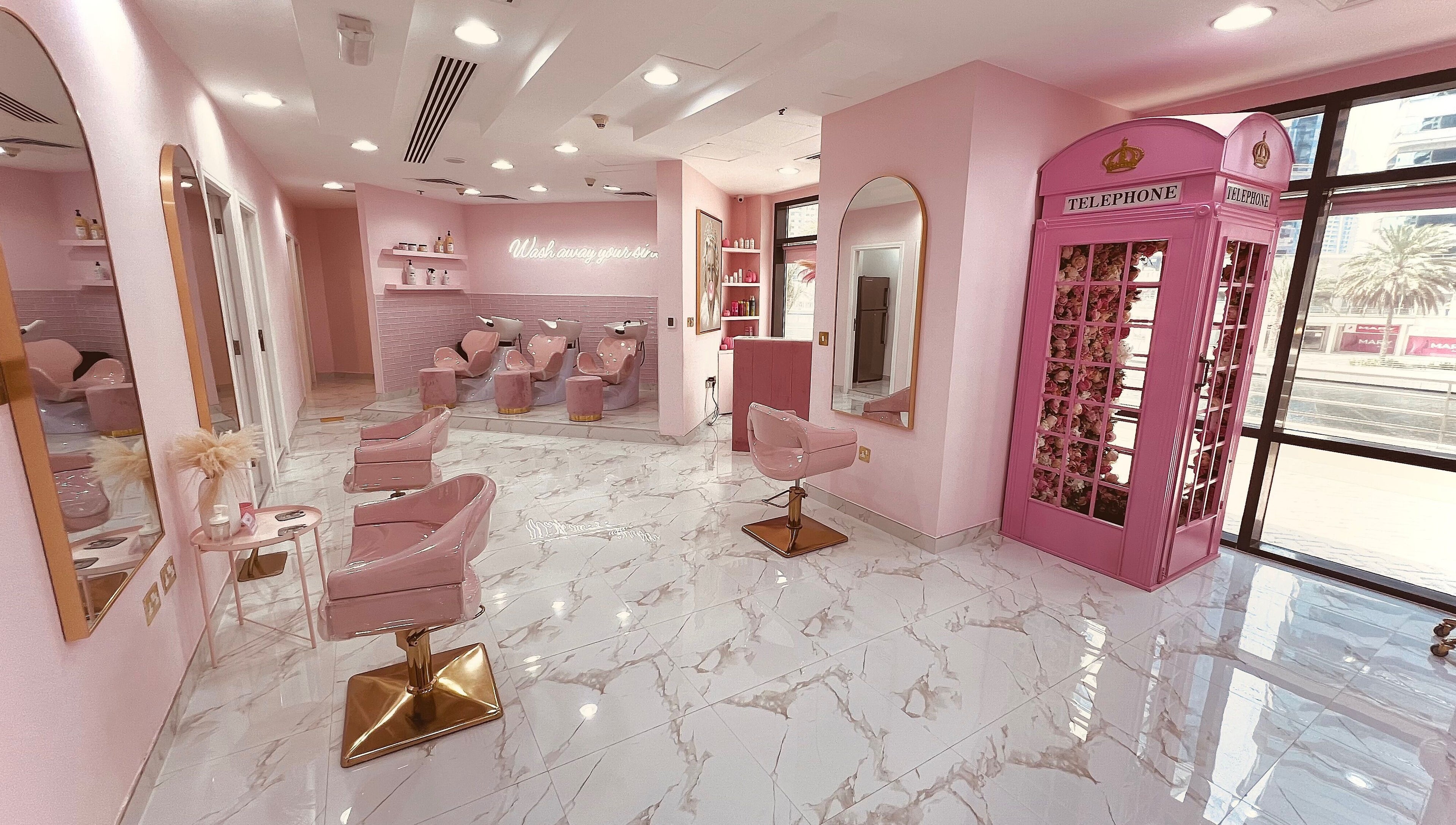 Stylish interior of The British Salon JLT, Dubai, Dubai, AE, featuring pink decor and plush seating.