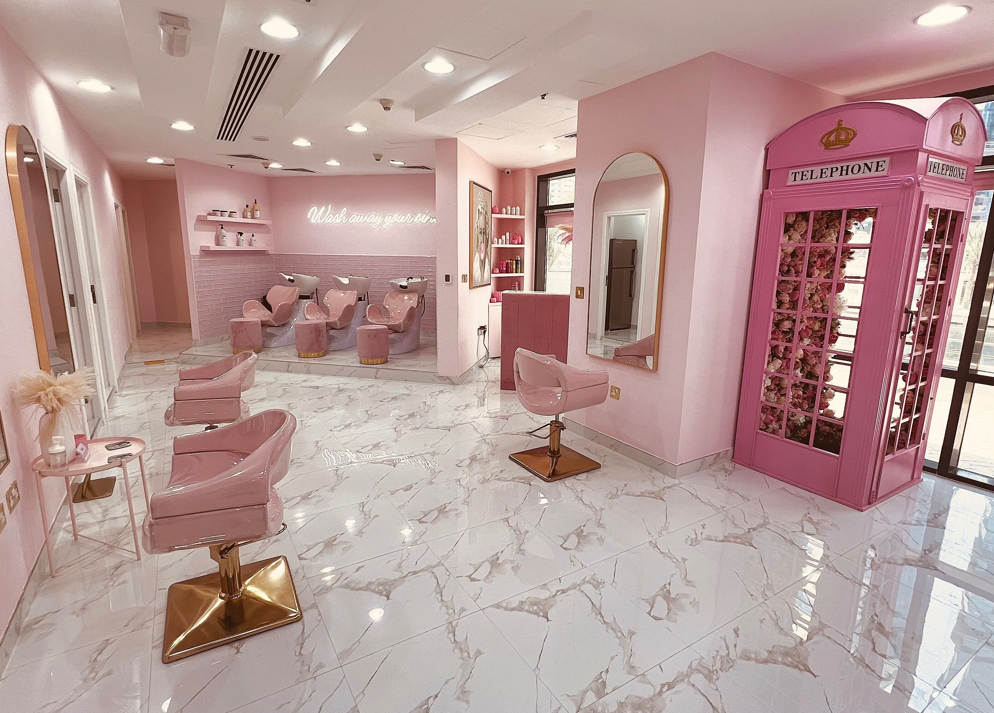 Stylish interior of The British Salon JLT, Dubai, Dubai, AE, featuring pink decor and plush seating.