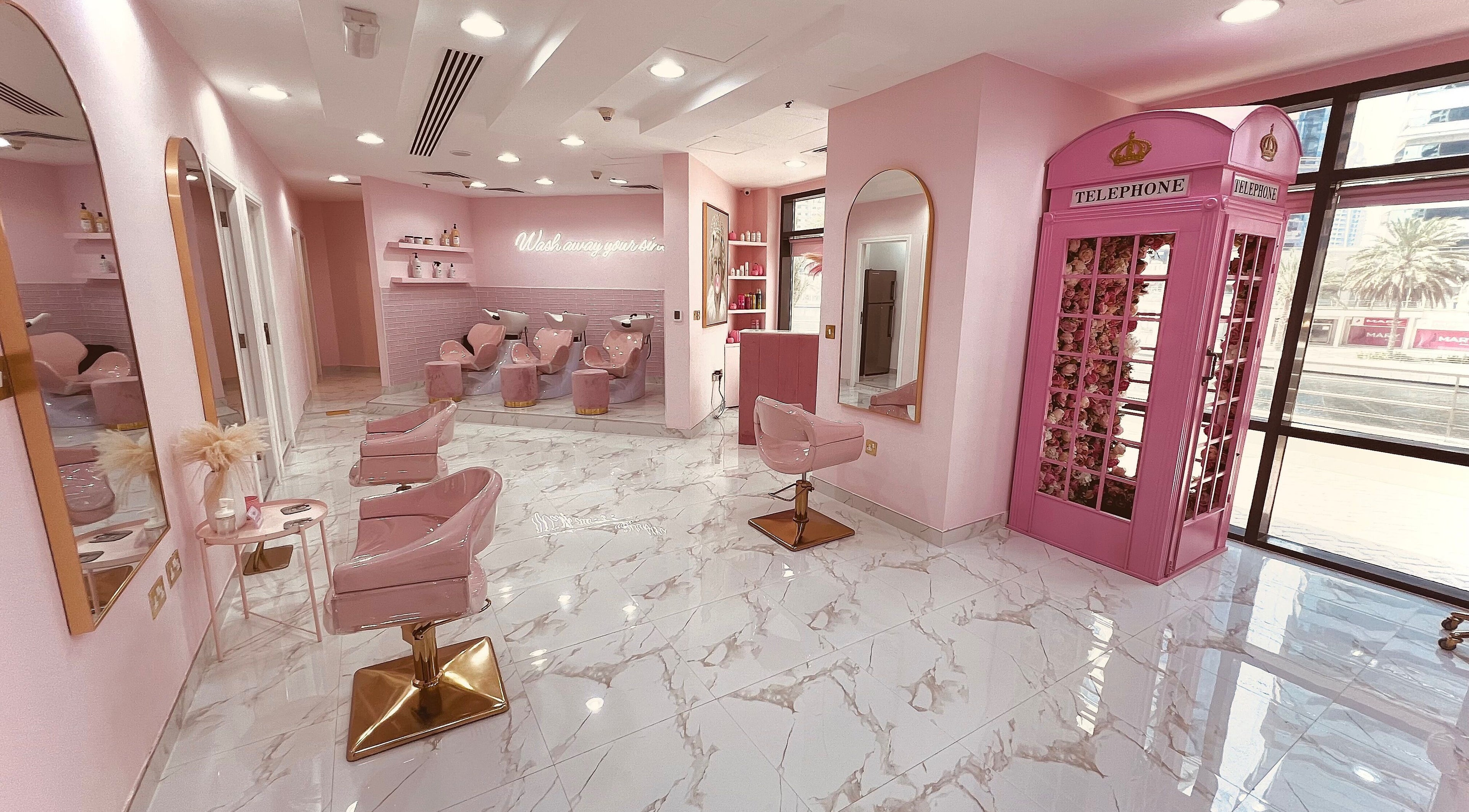 Stylish interior of The British Salon JLT, Dubai, Dubai, AE, featuring pink decor and plush seating.