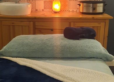 Cozy massage room at Renew Beauty Studio, Bangor, Northern Ireland, GB, featuring a plush table and ambient lighting.