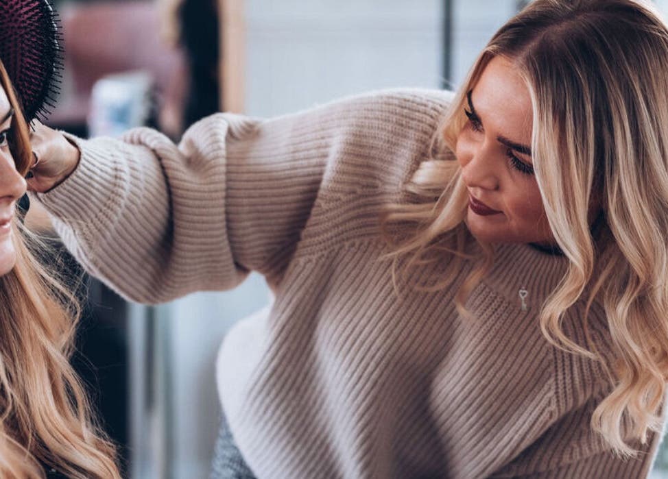 Stylist perfecting hair at The Studio by Lois, Shefford, England, GB.