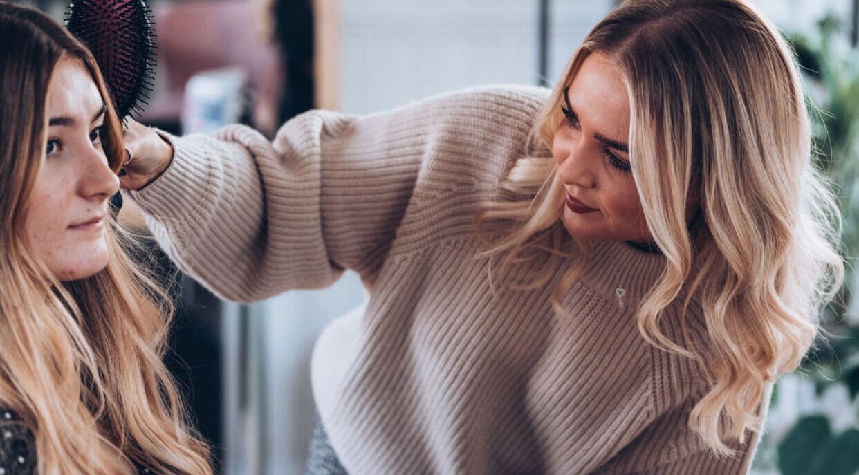 Stylist perfecting hair at The Studio by Lois, Shefford, England, GB.