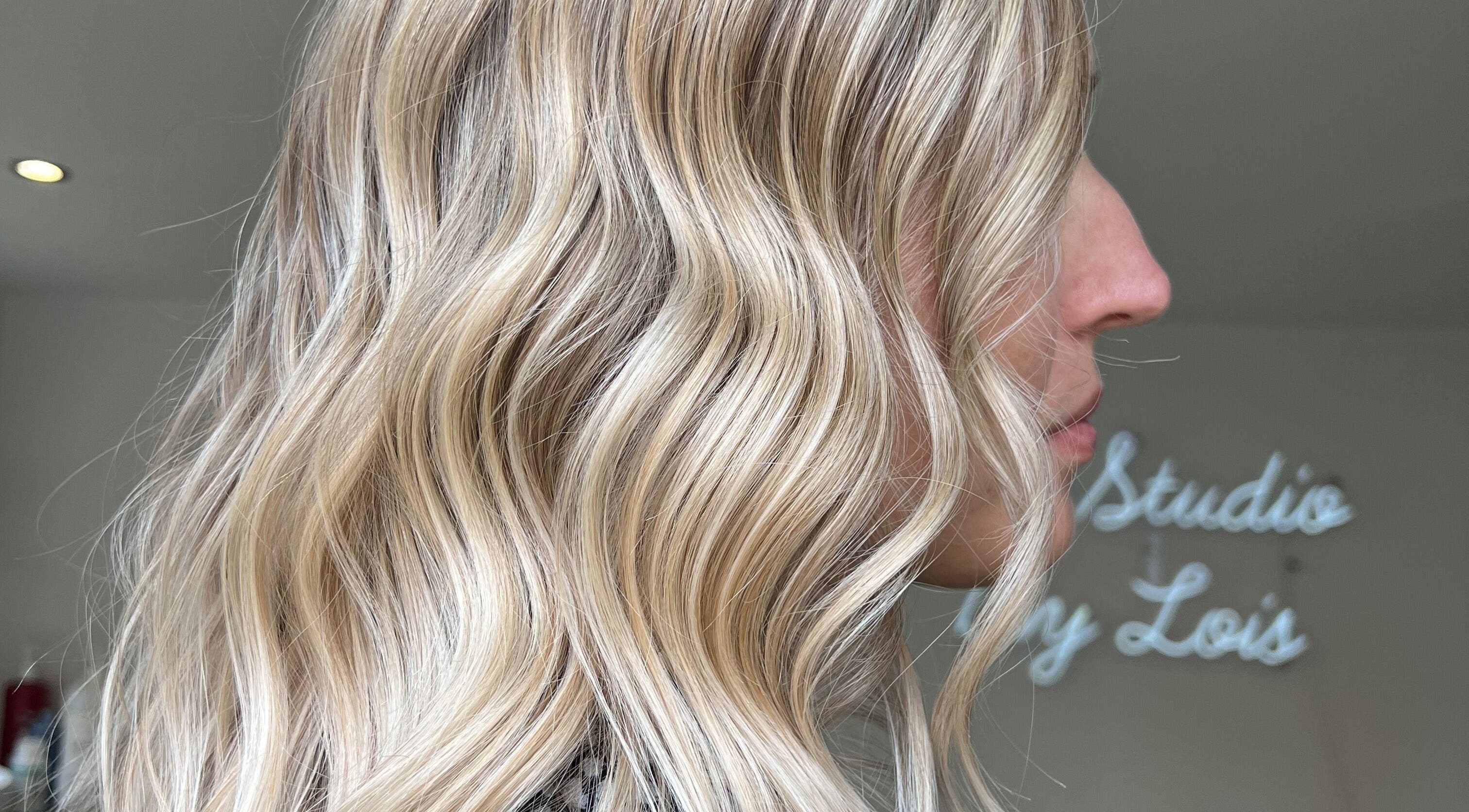 Elegant blonde waves hairstyle at The Studio by Lois in Shefford, England, GB with serene ambiance.