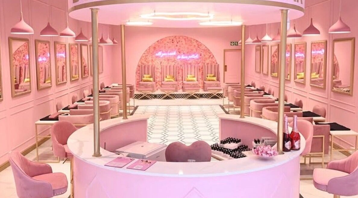 Chic pink interior of BOA Beauty Bar East Gate in Germiston, Gauteng, ZA with plush seating and stylish decor.