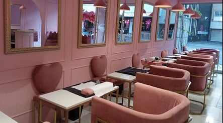 Elegant pink interior of BOA Beauty Bar Kloof Street, Cape Town, Western Cape, ZA, featuring plush seating and mirrors.