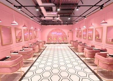 Chic interior of BOA Beauty Bar - Mall Of The South, Alberton, Gauteng, ZA. Pink seating and mirrors line the walls.