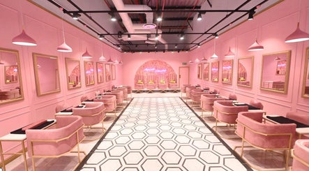 Chic interior of BOA Beauty Bar - Mall Of The South, Alberton, Gauteng, ZA. Pink seating and mirrors line the walls.