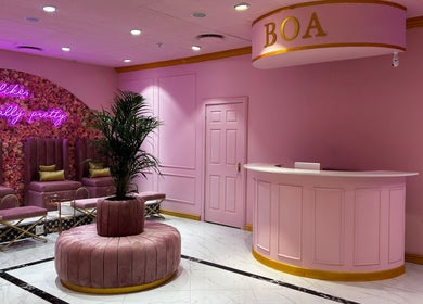 Luxurious pink interior of BOA Beauty Bar Rondebosch in Cape Town, Western Cape, ZA with plush seating and floral decor.