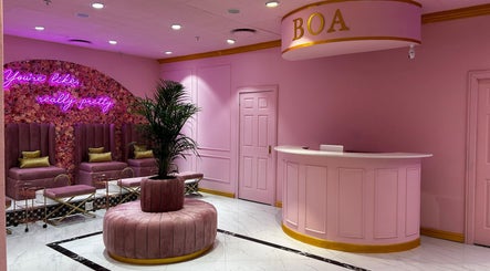 Luxurious pink interior of BOA Beauty Bar Rondebosch in Cape Town, Western Cape, ZA with plush seating and floral decor.
