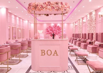 Chic interior of BOA Beauty Bar Durbanville, Cape Town, Western Cape, ZA, featuring pink decor and luxurious seating.