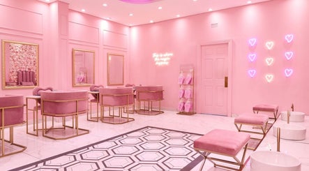Chic pink interior of BOA Beauty Bar Durbanville, Cape Town, Western Cape, ZA with elegant seating and neon lights.