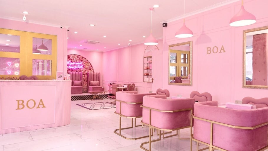 Chic pink interior of BOA Beauty Bar Sea Point, Cape Town, Western Cape, ZA showcasing modern decor and seating.