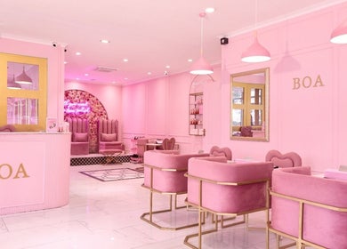 Chic pink interior of BOA Beauty Bar Sea Point, Cape Town, Western Cape, ZA showcasing modern decor and seating.
