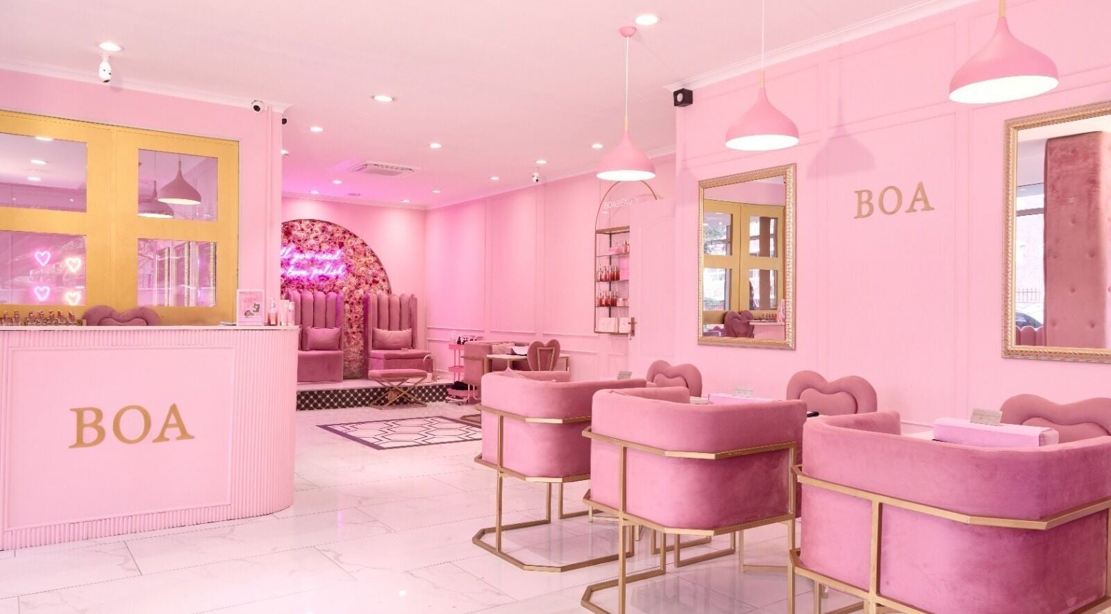 Chic pink interior of BOA Beauty Bar Sea Point, Cape Town, Western Cape, ZA showcasing modern decor and seating.