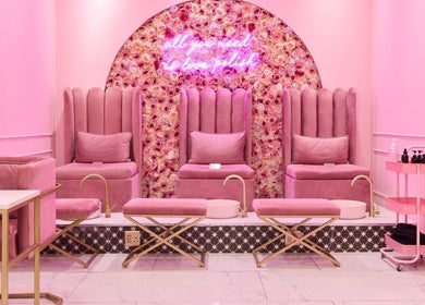 Chic pink seating area at BOA Beauty Bar Sea Point, Cape Town, Western Cape, ZA with plush decor and floral wall.