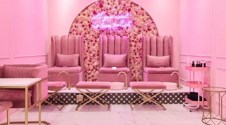 Chic pink seating area at BOA Beauty Bar Sea Point, Cape Town, Western Cape, ZA with plush decor and floral wall.