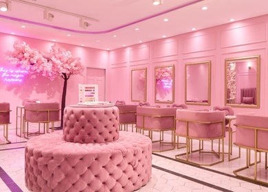 Elegant pink interior of BOA Beauty Bar Westlake in Cape Town, Western Cape, ZA with plush seating and vibrant decor.
