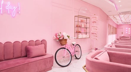 Chic pink interior at BOA Beauty Bar Green Point, Cape Town, Western Cape, ZA with decorative bicycle display.