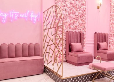 Elegant pink interior of BOA Beauty Bar Plumstead, Cape Town, Western Cape, ZA with plush seating and neon sign.