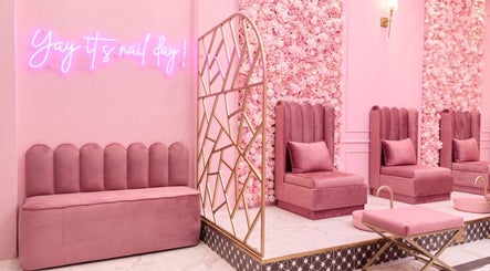 Elegant pink interior of BOA Beauty Bar Plumstead, Cape Town, Western Cape, ZA with plush seating and neon sign.