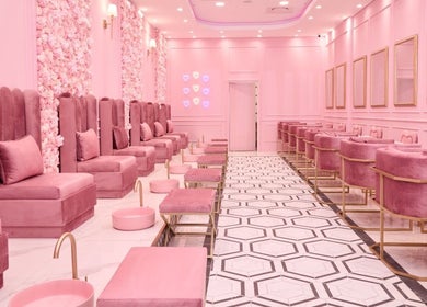 Chic pink interior of BOA Beauty Bar Plumstead, Cape Town, Western Cape, ZA with plush seating and floral decor.