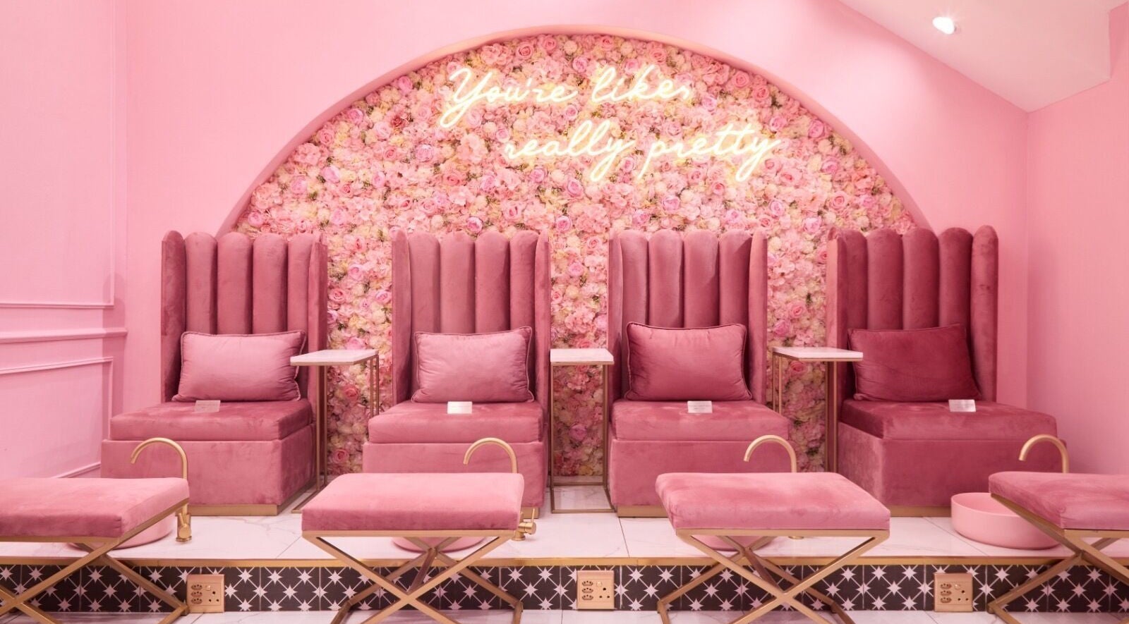 Elegant pink seating with floral backdrop at BOA Beauty Bar Kloof Street, Cape Town, Western Cape, ZA.