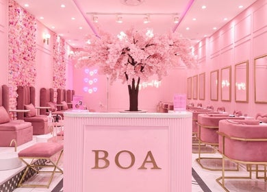 Chic pink interior of BOA Beauty Bar Riverlands Mall, Cape Town, Western Cape, ZA with plush seating and floral decor.