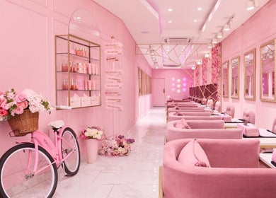 Elegant pink interior of BOA Beauty Bar Green Point in Cape Town, Western Cape, ZA with plush seating and floral decor.