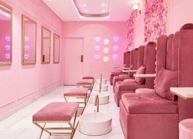 Chic pink lounge at BOA Beauty Bar Green Point, Cape Town, Western Cape, ZA with plush seating and neon decor.