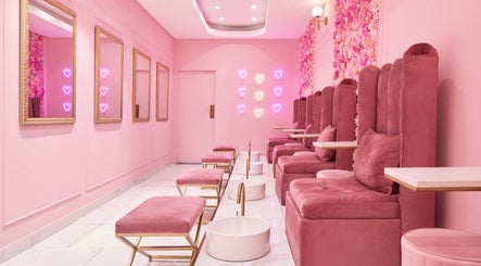 Chic pink lounge at BOA Beauty Bar Green Point, Cape Town, Western Cape, ZA with plush seating and neon decor.