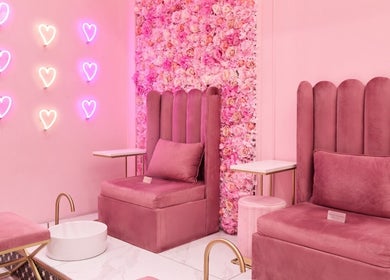 Elegant pink seating area at BOA Beauty Bar Green Point, Cape Town, Western Cape, ZA with heart neon lights.
