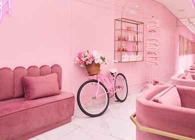 Chic pink lounge at BOA Beauty Bar Green Point, Cape Town, Western Cape, ZA showcasing plush seating and decor.