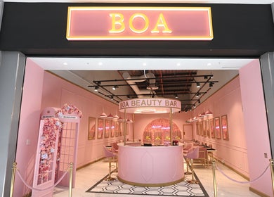 Chic entrance of BOA Beauty Bar Table Bay in Cape Town, Western Cape, ZA with floral decor and stylish seating.