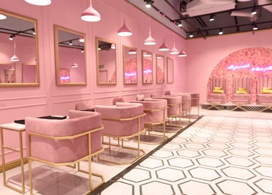 Chic interior of BOA Beauty Bar Table Bay in Cape Town, Western Cape, ZA with pink seating and elegant mirrors.